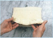 Picture of next step of encasing butter - baker finishes business letter fold